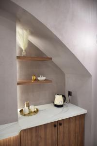a stairway with a white counter top and a kitchen at Incanto Luxury Suites 2 in Nafpaktos