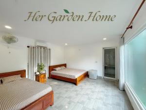 a bedroom with two beds and a sign for her garden home at Her Garden Home in Phu Quoc