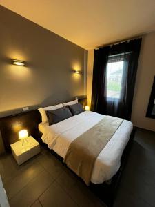 a bedroom with a large bed and a window at SLEEP & FLY Bergamo Centro in Bergamo