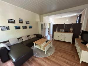 a living room with a couch and a table at Ferienwohnung Obernahmer in Hagen