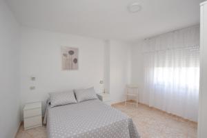 En eller flere senge i et værelse på Apartamento Mar Muxia