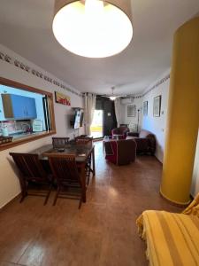 a living room with a table and chairs and a couch at Apartamento Zahara in Zahara de los Atunes
