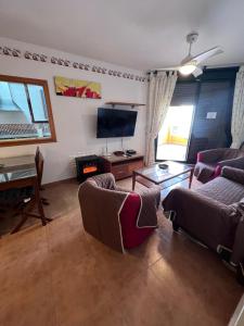 a living room with two couches and a television at Apartamento Zahara in Zahara de los Atunes