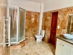 a bathroom with a toilet and a shower and a sink at Superbe Maison à Saint-Ouen in Saint-Ouen +24 photos