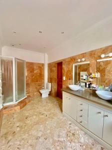 a large bathroom with two sinks and a toilet at Superbe Maison à Saint-Ouen in Saint-Ouen