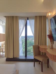 a room with a table and a chair and a window at Triann Condo Staycation Davao in Aeon Towers in Davao City