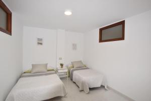 En eller flere senge i et værelse på Apartamento Mar de Muxía