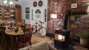 a dining room with a table and a wood stove at Kountry Living Bed and Breakfast in Oneonta