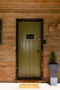 a green door with a sign that reads time shuttle at Self contained romantic Farmstay in Waipara wine country with bath and fire in Waipara