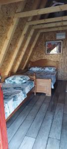 two beds in the attic of a log cabin at Etno selo -ŠAPAT- in Šavnik