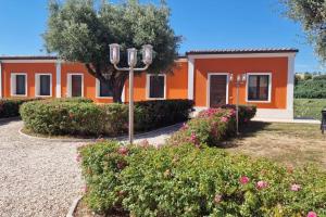 an orange house with bushes in front of it at Agriturismo il maniero in Ancona