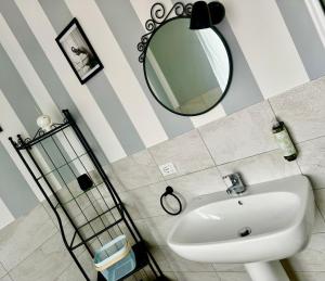 a bathroom with a sink and a mirror at civico 250 in Pescara