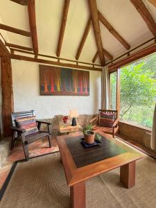 a living room with a table and some chairs at ApartaHotel La Leyenda in Villa de Leyva
