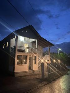 a large house with a balcony at night at House in beautiful nature in Pazarić