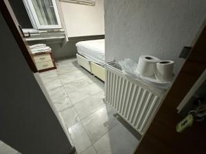a room with a bed and two rolls of toilet paper at Nr1 Pansiyon in Canakkale