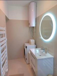 a bathroom with a washing machine and a sink at Emma & Toni in Biograd na Moru
