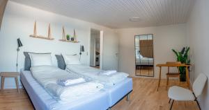 a living room with a blue couch with two pillows at The Black House Tuapannguit 48 in Nuuk