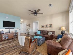 sala de estar con sofá y TV de pantalla plana en The Perfect Bay-Front Destination, en Galveston