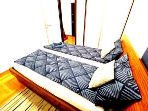 a bed with black and white pillows on a boat at LuxApart Bascarsija Old City Centar free parking in Sarajevo