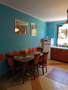 a kitchen with a dining room table and chairs at Strażnica Pod Lasem in Lasowka