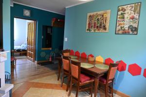 a dining room with a wooden table and chairs at Strażnica Pod Lasem in Lasowka