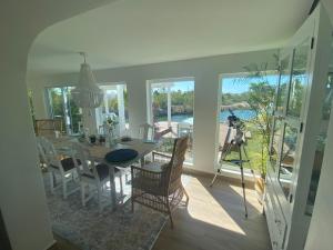 a dining room with a table and a view of the water at Palm Point Loft in Turtle Cove