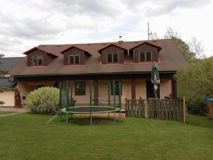 a house with a trampoline in front of it at U Janka in Mosty u Jablunkova