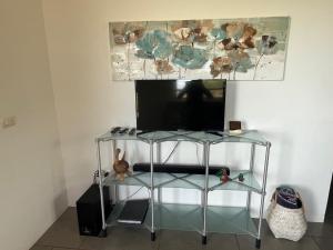 a television on a stand in a living room at El nido del tucán in Torio