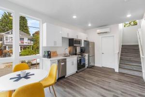 a kitchen with a table and a table and chairs at Highgarden The Seat of House Tyrell Sweet Suite in Seattle