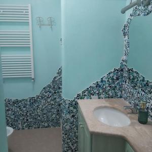 a bathroom with a sink and a shower at Sardegna, House of Flamingos Olbia Apartment in Olbia