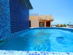 a swimming pool next to a building at Hotel Villas Ponto Holbox in Holbox Island
