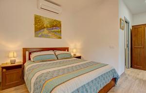 a bedroom with a bed with two night stands and two lamps at Finca el Almendro Archez in Árchez