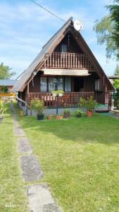 a house with a grass yard in front of it at Balatonmáriafürdő Szabó apartman in Balatonmáriafürdő