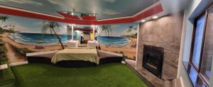 a bedroom with a mural of the ocean and a fireplace at Inn of the Dove - Romantic Luxury Suites with Jacuzzi & Seasonal Fireplace at Harrisburg-Hershey-Philadelphia, PA in Harrisburg