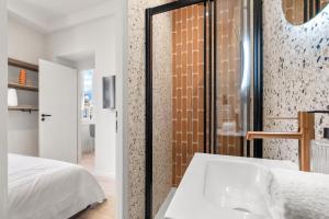 a bedroom with a white bed and a tub at RIVIERA COZY - Place Massena in Nice