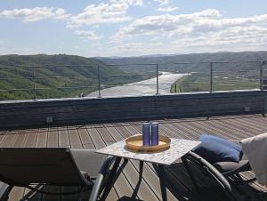 a table with a candle on top of a roof at la maison bleue in Ponsas +15 photos