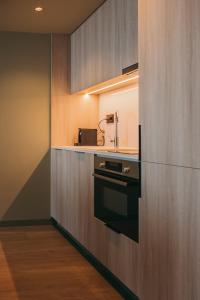 a kitchen with a sink and a stove at Hotels 705 Porto Prime Home in Porto