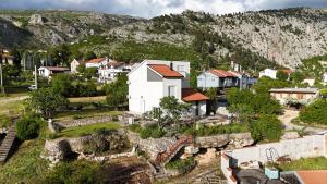 an aerial view of a town with a mountain at Villa The Cave in Blagaj
