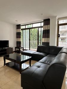 a living room with a couch and a coffee table at Secluded-Loft-2 BEDROOM-2-Bath in Dar es Salaam