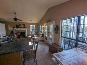 a kitchen and living room with a table and chairs at Greers Ferry Lake Cabin in Heber Springs