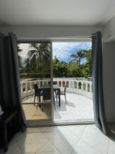 a room with a view of a table and a balcony at HUMMINGBIRD CABARETE in Cabarete