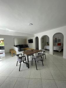 HUMMINGBIRD CABARETE في كاباريتي: غرفة معيشة مع طاولة وكراسي وسرير