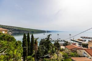 a view of a body of water with trees and buildings at Casa Tradizionale Volosko in Opatija