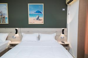 a bedroom with a bed and a blue umbrella at Hotel Idi in Vlorë