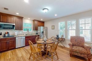 a kitchen and dining room with a table and chairs at Charming apartment with beautiful marsh views and shared patio in Fernandina Beach