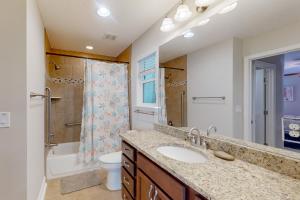 a bathroom with a sink and a toilet and a shower at Charming apartment with beautiful marsh views and shared patio in Fernandina Beach +13 photos