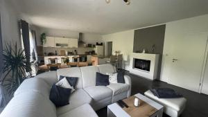 sala de estar con sofá blanco y mesa en Ferienwohnung am Chursbach en Callenberg