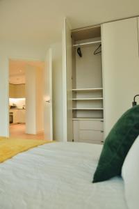 a bedroom with a bed and a open closet at Apartments next to the O2 Arena 10 in London