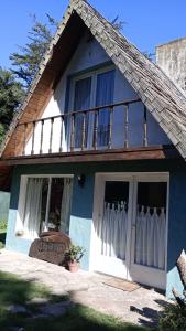 a blue house with a balcony on top of it at Cabaña,Chalet Alpino Bosques de Peralta Ramos in Mar del Plata