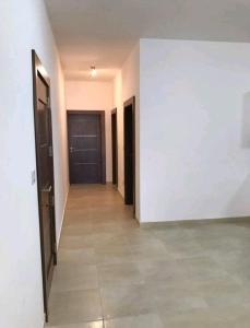 an empty hallway with two doors and a tile floor at Star Dream Apartment in Xgħajra